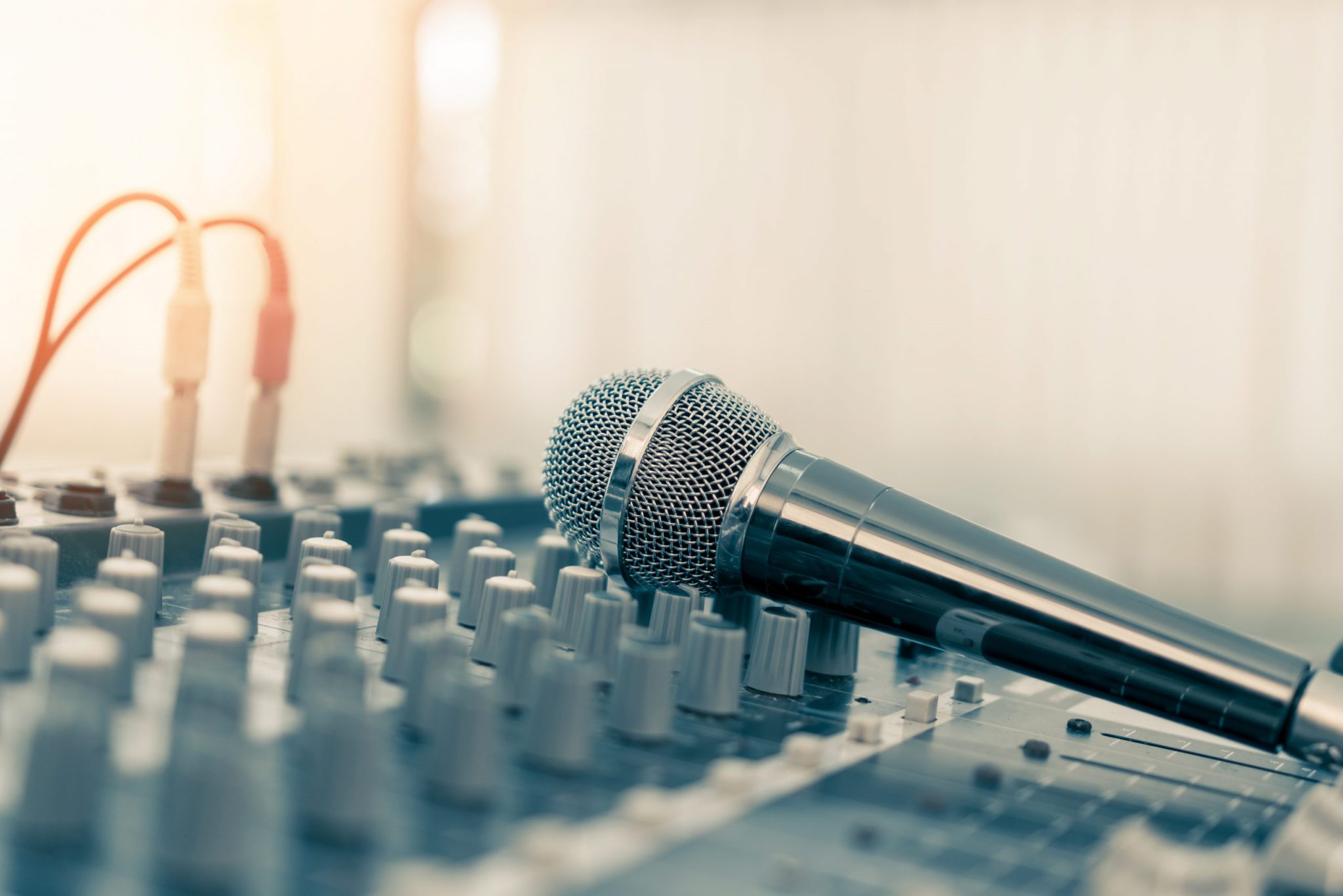 Microphone Laying on DJ Mixing Board