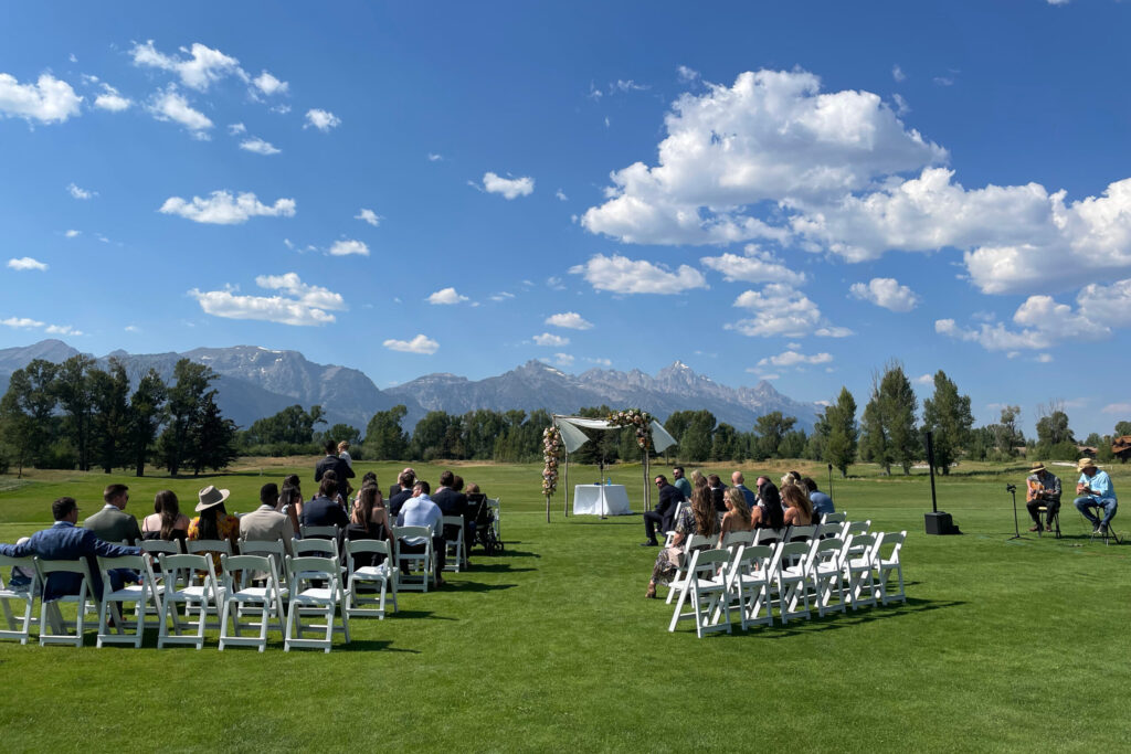 Wedding ceremony guitar with Teton backdrop